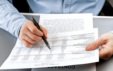 Cropped view of businessman works with financial papers at the table. Finance concept