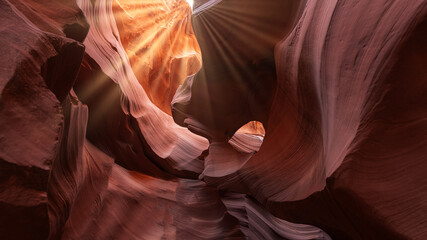 A ray of light streams from The Eye in Antelope Canyon. Abstract background concept. Sunlight in the famous Antelope Canyon near page, arizona, usa.