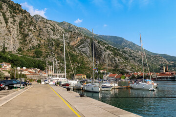 Fototapeta na wymiar Luxury yachts moored at the harbour in the Old Town of Kotor, Montenegro
