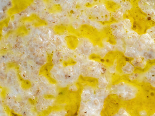 Appetizing porridge made from fresh milk with the addition of vegetable oil or butter. The texture of the surface of the porridge completely fills the food background.