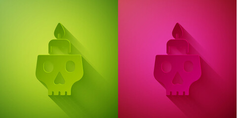 Paper cut Burning candle on a skull icon isolated on green and pink background. Day of dead. Paper art style. Vector.