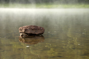 stones in the river in the fog