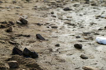 childrens shoes by the river