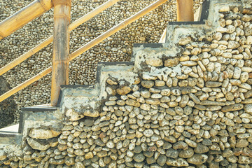 Pebble wall and staircase near sea