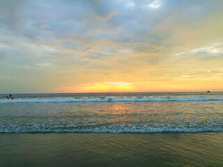 Fototapeta na wymiar sunset on the beach, wave on the beach, beautiful sunset view in the Indian Ocean.