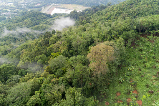 Aerial view drone shot of mountain tropical rainforest,Bird eye view image over the clouds Amazing nature background with clouds and mountain peaks.