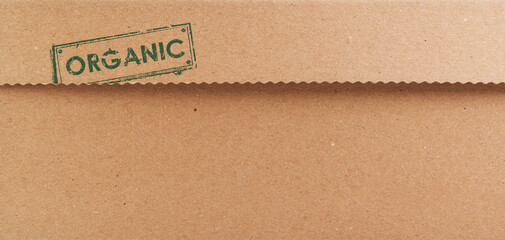 Brown Cardboard, Paper Board or Carton Background.Organic lettering on cardboard.Supplies for creating boxes and packaging. Pasteboard background. Natural brown cardboard surface.