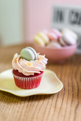 Sweet cupcakes for party. Fresh cupcakes decorated with cream cheese, blueberry and strawberry on modern concrete background. Sweet baked pastry. Easter cupcakes with fruit.