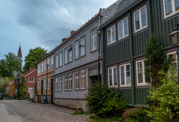 Fototapeta na wymiar The colorful back streets of the old city wharves district along the Nidelva river in Trondheim, Trondelag, Norway. Symbol of the historical role of Trondheim as a merchant city.