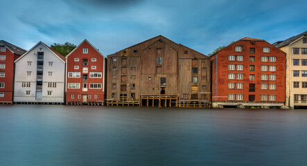 Obraz premium The colorful and iconic old city wharves along the Nidelva river in Trondheim, Trondelag, Norway. Symbol of the historical role of Trondheim as a merchant city.