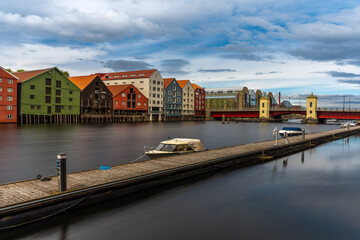Obraz premium The colorful and iconic old city wharves along the Nidelva river in Trondheim, Trondelag, Norway. Symbol of the historical role of Trondheim as a merchant city.
