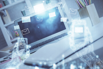 Desktop computer background in office and flying envelops hologram drawing. Double exposure. Electronic mail concept.