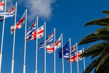 Row of flagpoles with the state flags of Georgia against the blue sky