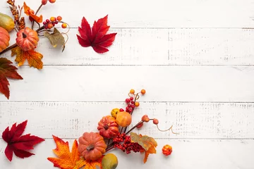 Foto op Canvas Festive autumn decor from pumpkins, berries and leaves on a white  wooden background. Concept of Thanksgiving day or Halloween. Flat lay autumn composition with copy space. © Svetlana Kolpakova