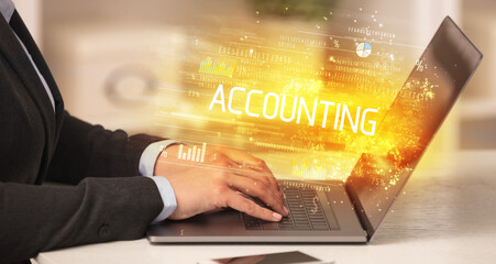 Closeup of businessman hands working on laptop with ACCOUNTING inscription, succesfull business concept