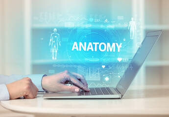 Doctor working a health check with ANATOMY inscription, recording medical test results