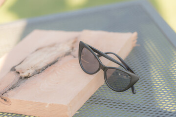 Fototapeta na wymiar Cat eye sunglasses model shoot in a summer day closeup. Selective focus