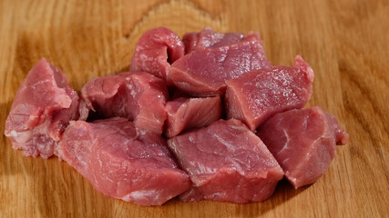 raw red meat on wooden board