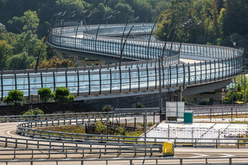 Overpass. Winding modern road. Detour. Highway. Road fence. Turn of the road. No people. No car.
