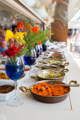 buffet table with tropical flowers in vases
