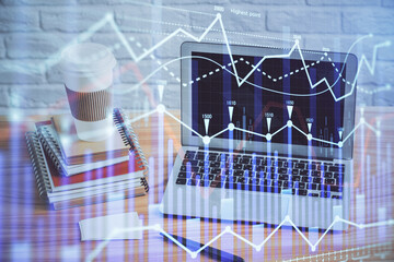 Financial graph colorful drawing and table with computer on background. Multi exposure. Concept of...