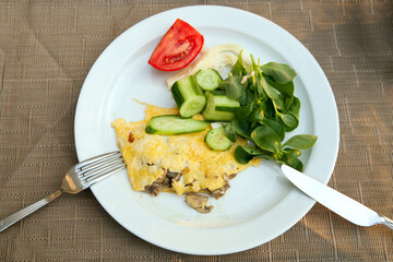 Breakfast with fried eggs with mushrooms and green salad
