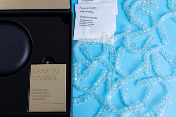 Invisalign transparent brackets package box on blue background