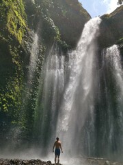 Guy in front of a waterfall