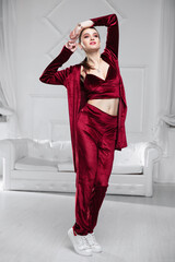 Attractive brunette dressed in a burgundy velor suit