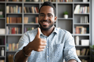Head shot portrait satisfied smiling African American man wearing glasses showing thumb up, excited businessman student looking at camera, positive customer recommending service, good quality
