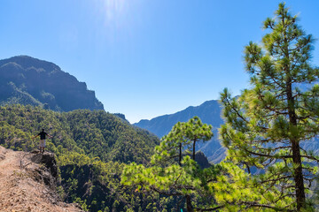 A young man looking at the landscape on the trek from the top of La Cumbrecita next to the mountains of the Caldera de Taburiente, La Palma island, Canary Islands, Spain