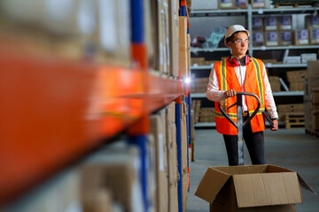 Male logist in the warehouse stands with a pallet loader and unloading goods