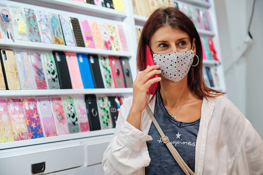 Adult Woman Wearing Mask At Phone Accesories Shop