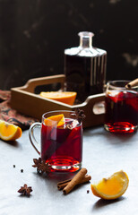 Mulled wine with slice of orange, cinnamon sticks and anise stars, winter drink
