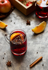 Mulled wine with slice of orange, cinnamon sticks and anise stars, winter drink
