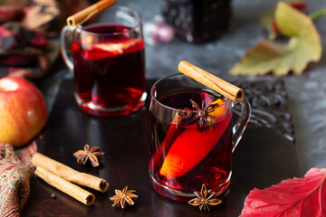 Mulled wine with slice of orange, cinnamon sticks and anise stars, winter drink