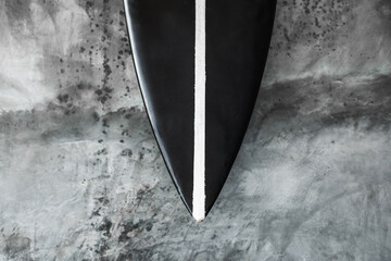 Black and white color surf board on gray concrete wall background. Contemporary interior design of...