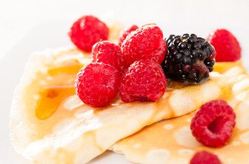 pancakes with raspberries, blackberries and honey