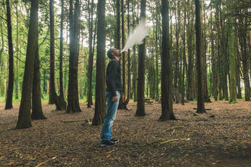 A man smoking electronic cigarette in the middle of the Sintra forest