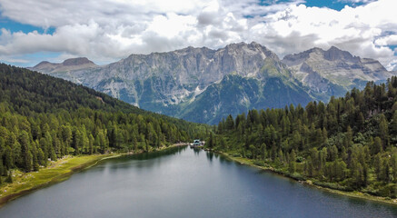 Fototapeta na wymiar Malghette Lake, located in Sun Valley at 1900 m a.s.l. in the heart of Adamello Brenta Nature Park, Trentino Alto Adige northern Italy. Italian alps