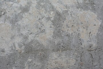 Old concrete surface with cracks and remnants of old paint