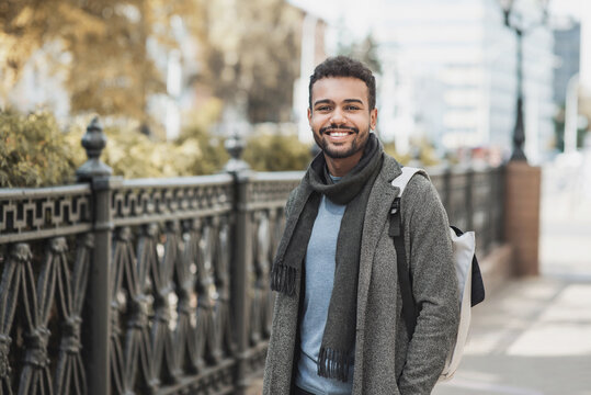 Handsome Joyful Man Autumn Portrait. Smiling Men Student Wearing Warm Clothes In A City In Winter