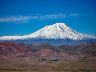 Fototapeta premium panoramic view of snow capped mount ararat mountain against blue sky in turkey