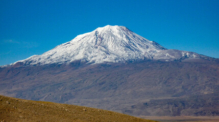 Fototapeta premium panoramic view of snow capped mount ararat mountain against blue sky in turkey