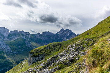 Obraz premium The steep path leading to the majestic Schaefler peak in the Alpstein mountain range around the Aescher cliff in Appenzell, Switzerland