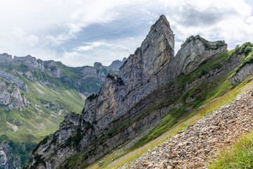 The Meglisalp village in Appenzell, Switzerland sitting betweeen the tall peaks of the Alpstein range in the Swiss Alps