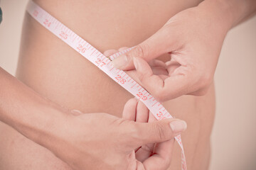 women Slim waist with a tape measure around it