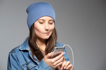 Girl listening to music on smartphone. - 374667976