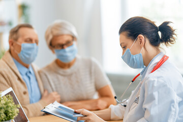 Fototapeta premium Doctor and senior couple wearing facemasks