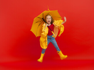 Kid with umbrella on colored background.